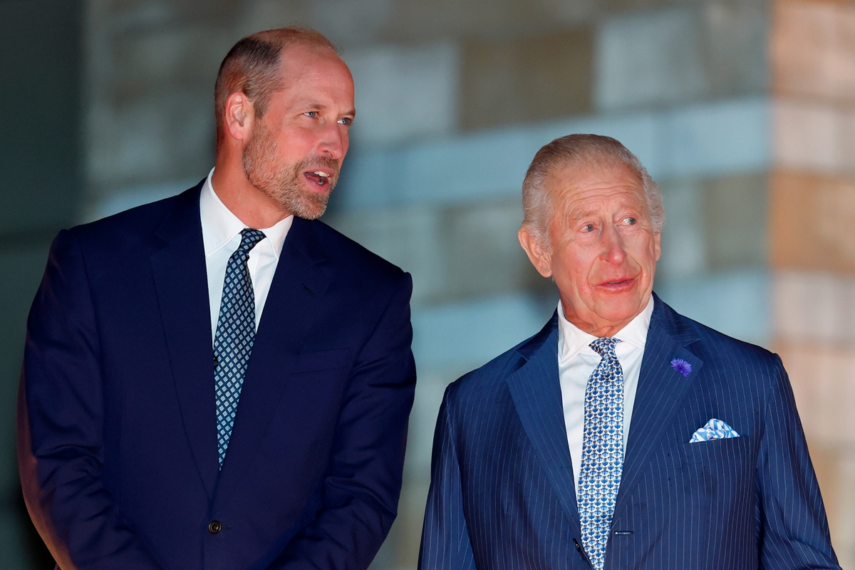 Foto colorida de dois homens conversando. Ele estão com blazer azul-escuro e gravata azul claro - Metrópoles