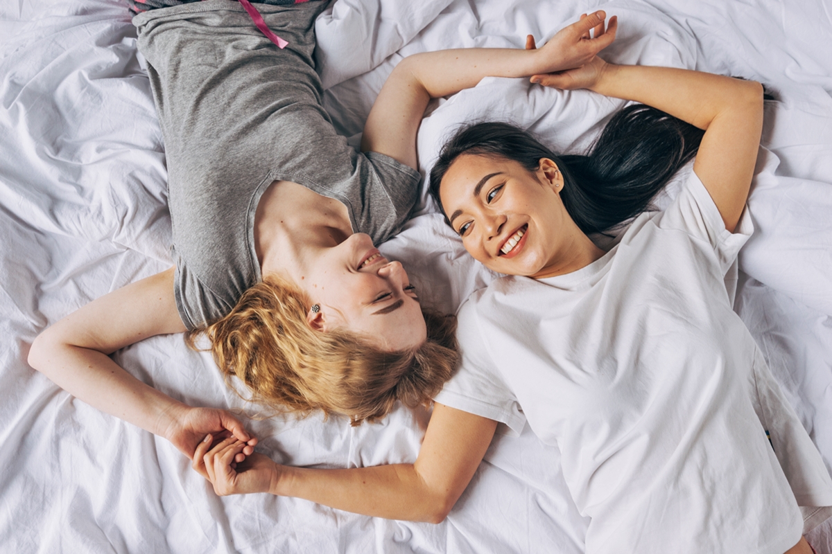 Foto colorida de mulheres felizes na cama